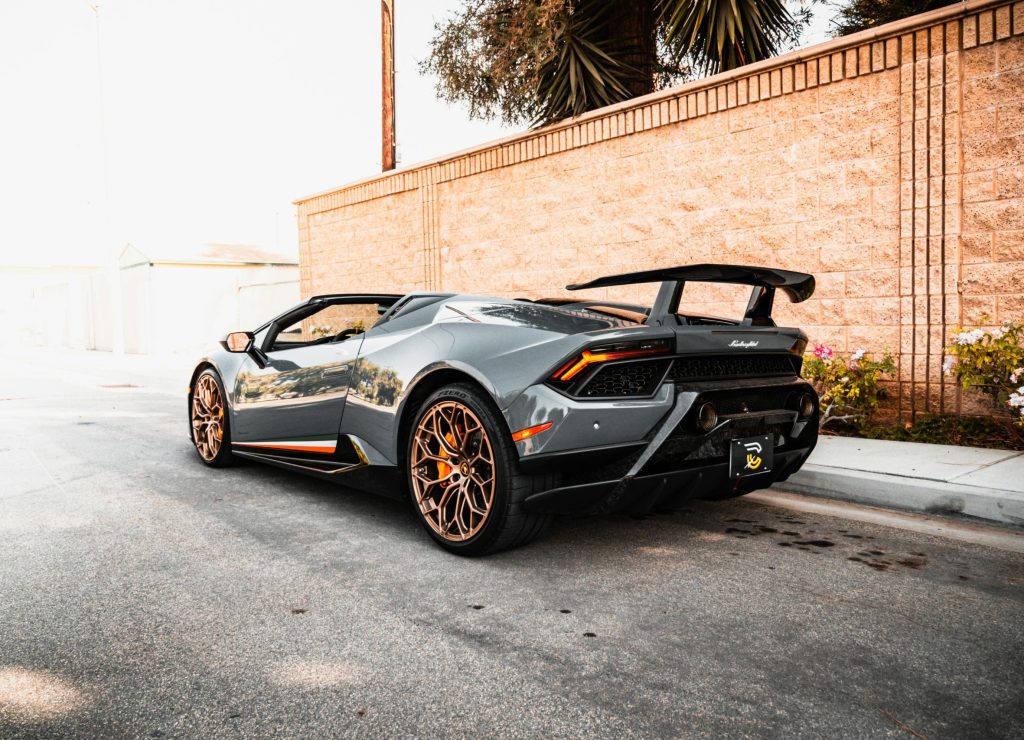 A sleek Lamborghini sports car parked in an urban setting, showcasing luxury automotive design.